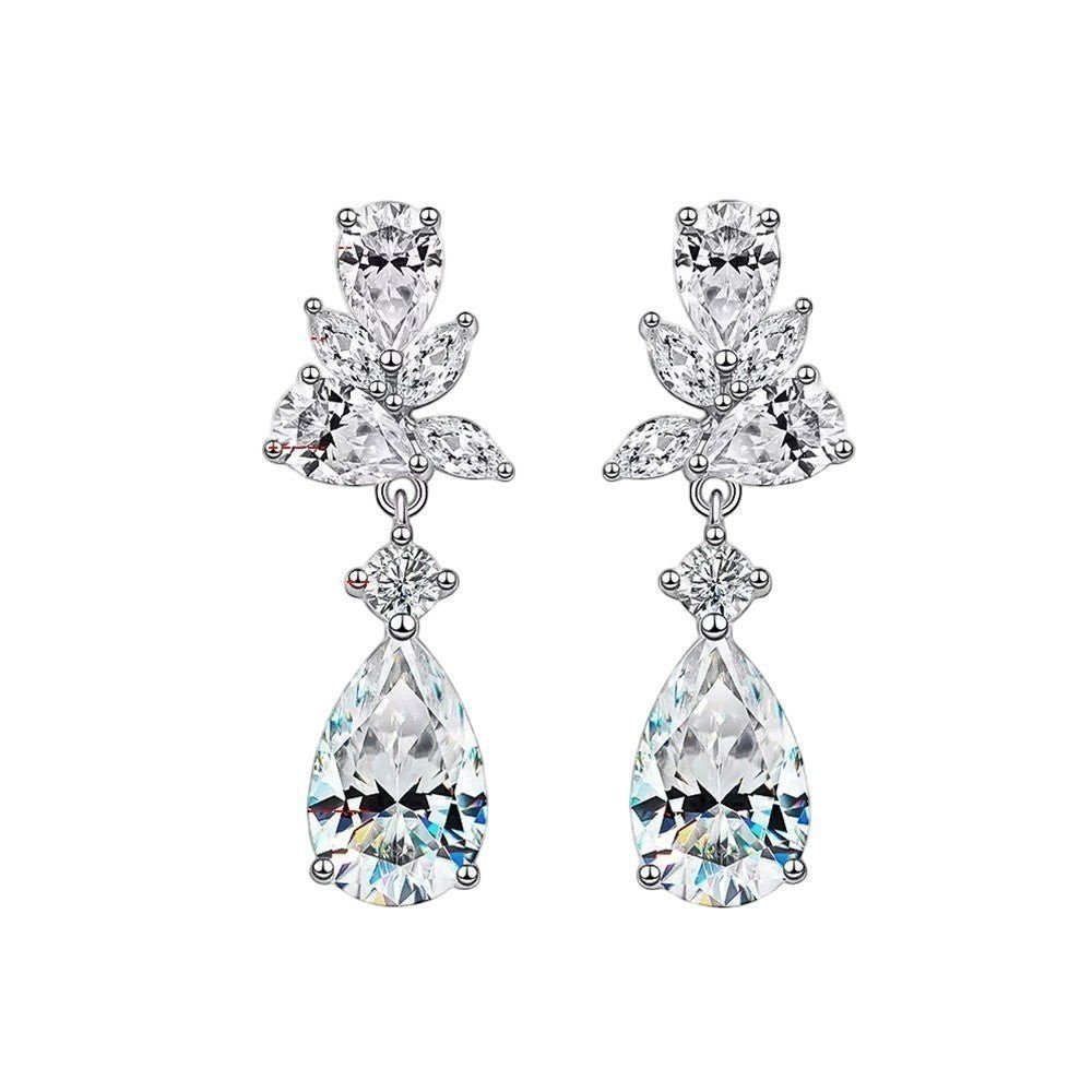 Emerald cut D Color moissanite drop earrings from Bee-Bees styled for an elegant evening look.