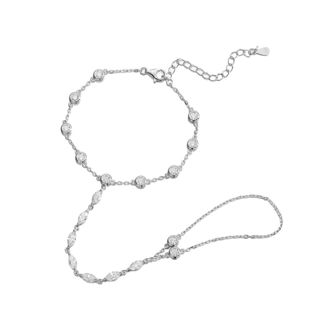 Elegant silver moissanite hand chain bracelet featuring round bezel-set stones, marquise-cut accents, a delicate finger loop, and an adjustable lobster clasp with extension chain, displayed on a white background.