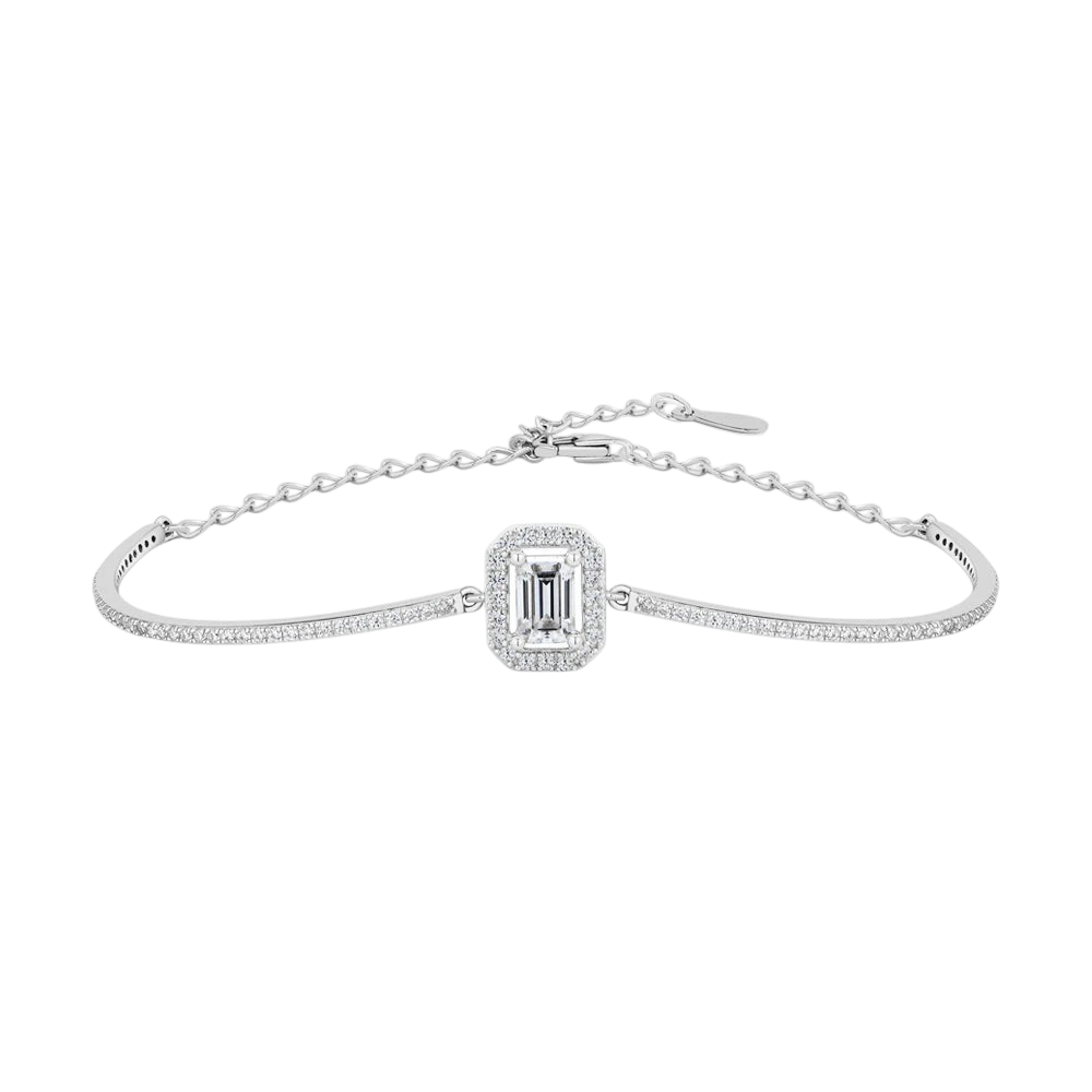 give me alt text
Elegant silver moissanite bracelet featuring a sparkling emerald-cut center stone surrounded by a halo of smaller stones, delicate pavé-set curved bands, and an adjustable chain clasp, displayed on a clean white background.